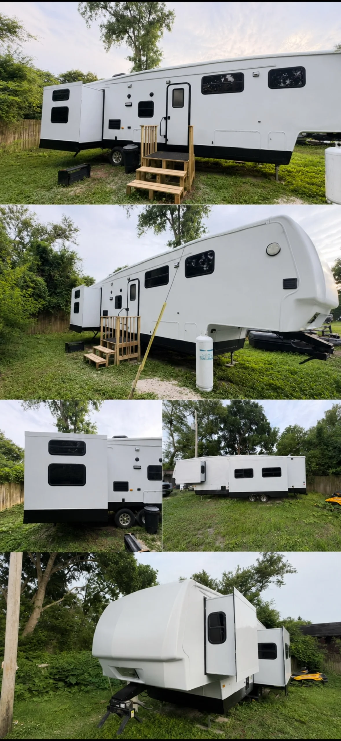 Side view of white fifth-wheel RV with slide-out and wooden entry steps in grassy yard.