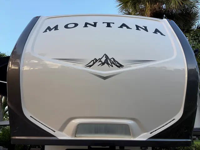 Close view of molded front cap on Montana fifth wheel RV with mountain graphic.